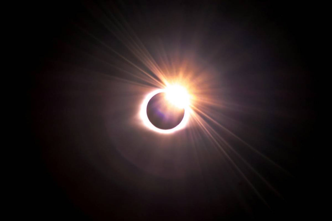 Solar eclipse with the sun’s rays shining on one side
