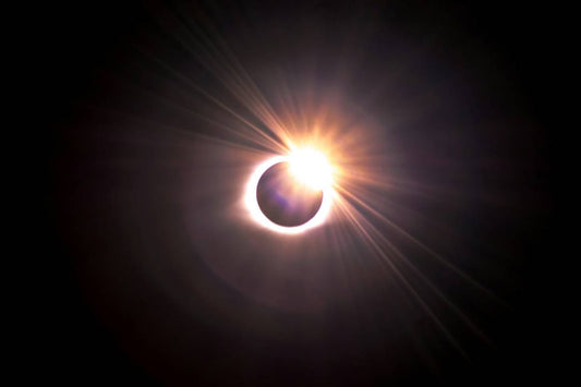 Solar eclipse with the sun’s rays shining on one side