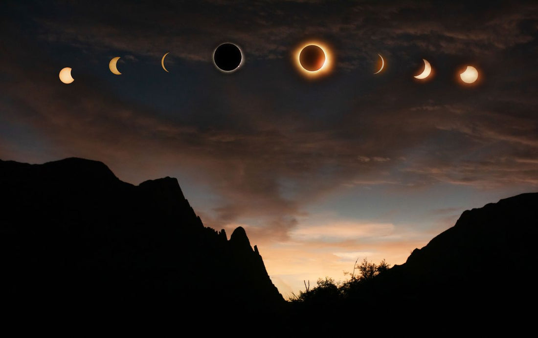 Solar eclipse phases progressing above a silhouetted landscape