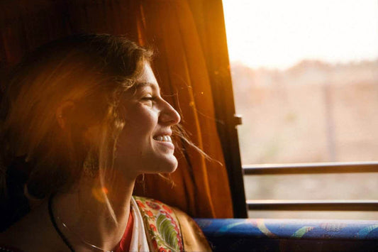 A woman in a sunny window.