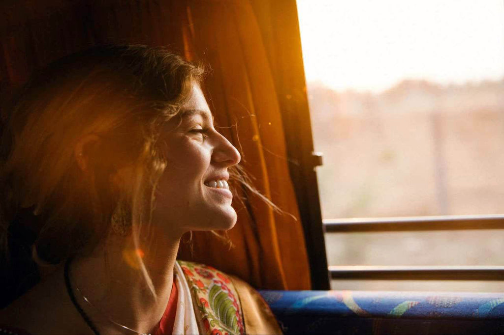 A woman in a sunny window.