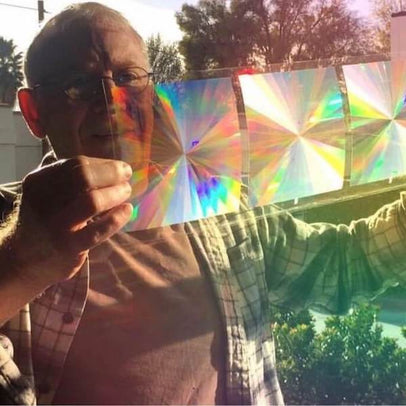Rainbow Symphony founder Mark quality testing a sheet of rainbow film